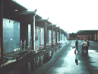 Photo showing a line of modern kilns: warm, wet air is being exhausted from the kilns